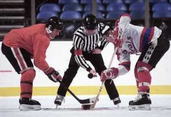 Players face each other in a hockey game.